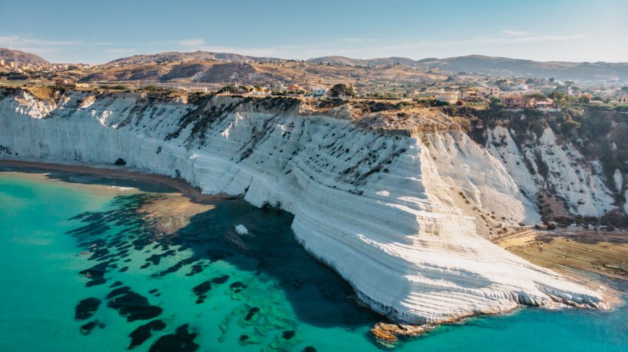 Aerial view of Scala dei Turchi white rocky cliff and of the turquoise sea below